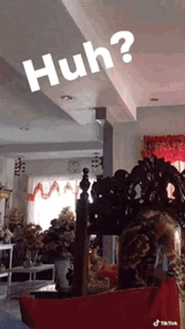 a living room with a couch and a ceiling that says huh on it