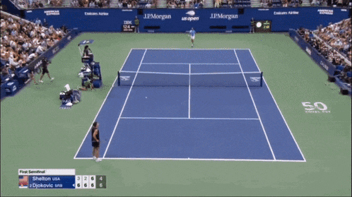 a tennis player is wearing a blue and white shirt with a lacoste logo