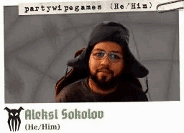 a picture of a man with a beard wearing a hat and glasses