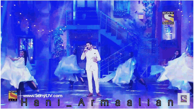 a man singing on a stage with a sony logo in the corner