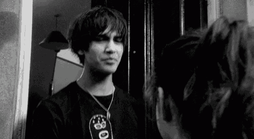 a man is looking at himself in a mirror .