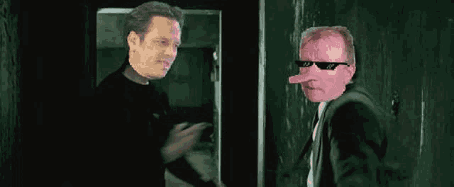 two men in suits and sunglasses are standing next to each other