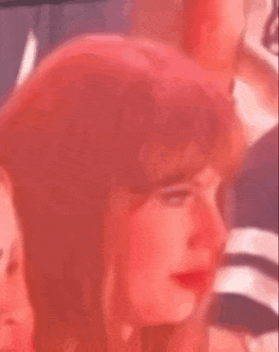 a close up of a woman 's face with red hair and red eyes