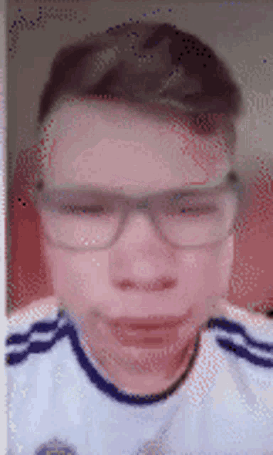 a close up of a person wearing glasses and a white shirt with the letter e on it