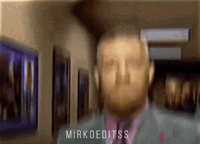 a blurry picture of a man with the name mirkoeditss on the bottom right