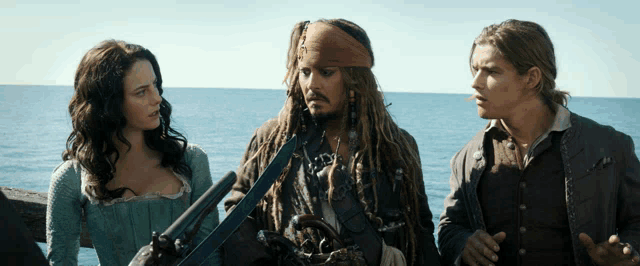a man with dreadlocks is holding a gun while standing next to a woman