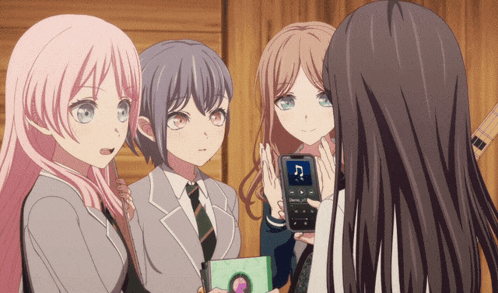 a group of anime girls are looking at a cell phone with a song on it that starts with the letter c