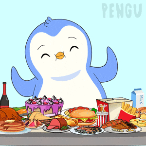 a penguin is sitting at a table full of food including a coca cola