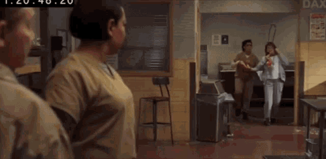 a man and a woman are standing next to each other in a bathroom .