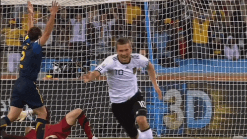 a soccer player with the number 10 on his jersey celebrates a goal