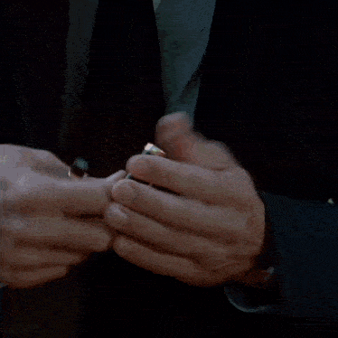 a close up of a person 's hand holding a black pen