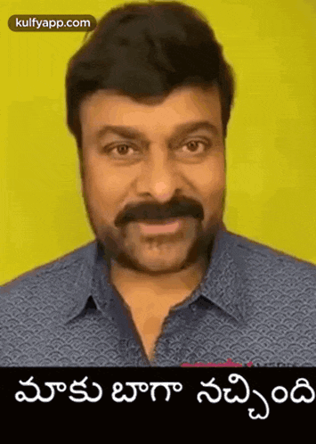 a man with a mustache is making a funny face while wearing a blue shirt .