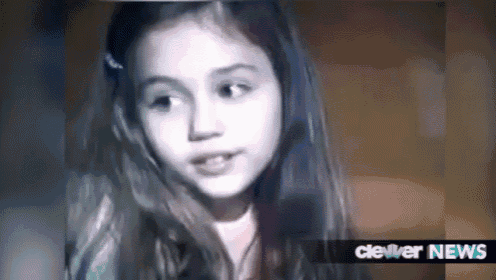 a close up of a young girl 's face with the words cleveland news below her