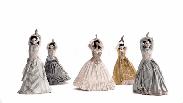 a group of women in long dresses are dancing in a row
