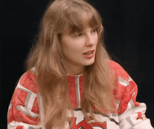 a woman wearing a red and white sweater that says ' ohio state ' on it