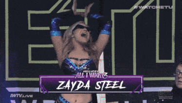 a woman in a wrestling outfit is standing in front of a sign that says watchetu