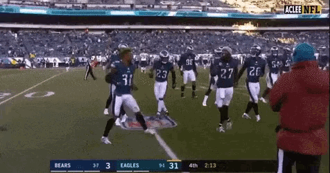 a football game is being played between the bears and the eagles .