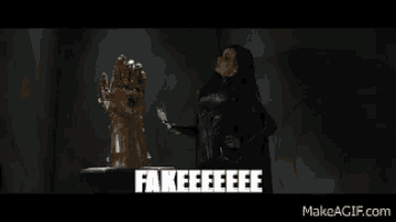 a woman in a black cape is holding a glove and says fakeeeee .