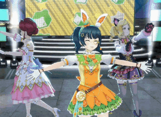 a girl with bunny ears on her head is dancing with two other girls