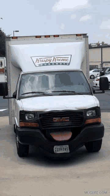 a white gmc truck with a krispy kreme doughnut logo on it