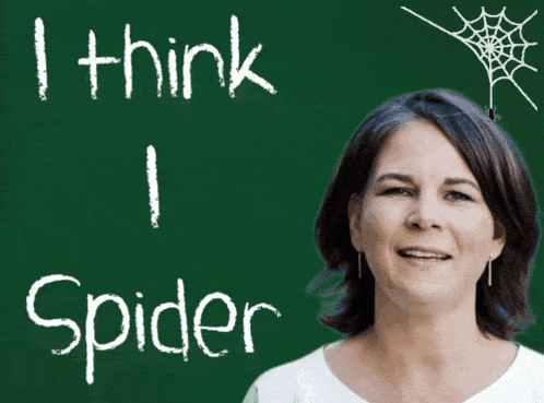 a woman is smiling in front of a green board that says i think i spider
