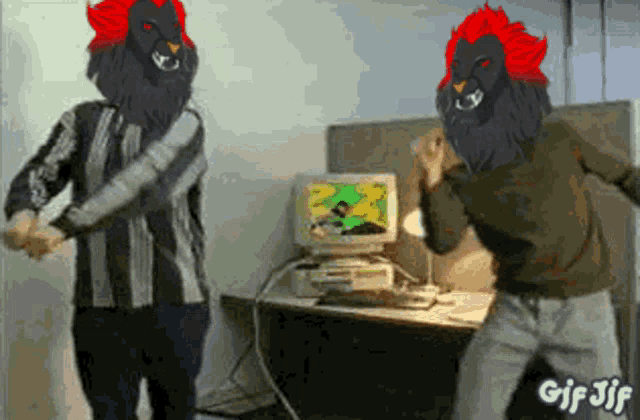 a gif of two men dancing in front of a computer monitor