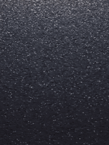 a close up of a bunch of cookies on a black surface