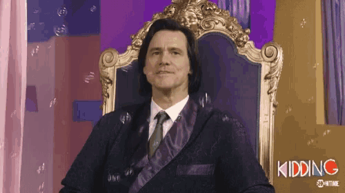 a man in a suit and tie is sitting in a throne surrounded by bubbles .