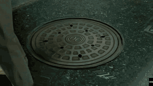 a video game scene with a manhole cover and a sign that says css on it