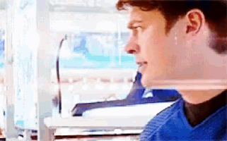 a man in a blue shirt is looking to the side