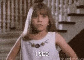 a little girl in a white dress is standing in front of a set of stairs and says `` i see '' .