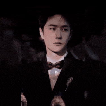 a man in a suit and bow tie is surrounded by lightning and the words " miss bomb " are visible