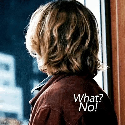 a person looking out a window with the words " what no " on the back of their jacket