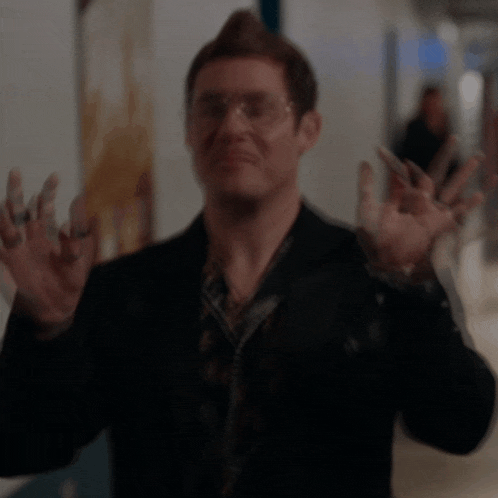 a blurry picture of a man in a suit and glasses
