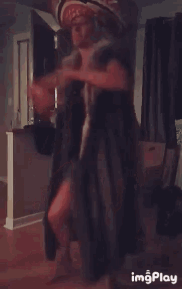 a man and a woman are dancing in a living room with the words imgplay at the bottom