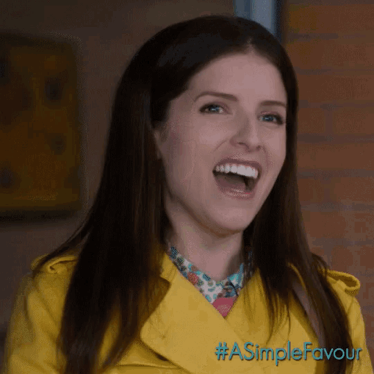 a woman wearing a yellow jacket with #a simple favour written on the bottom