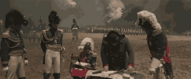 a group of men in military uniforms are in a field