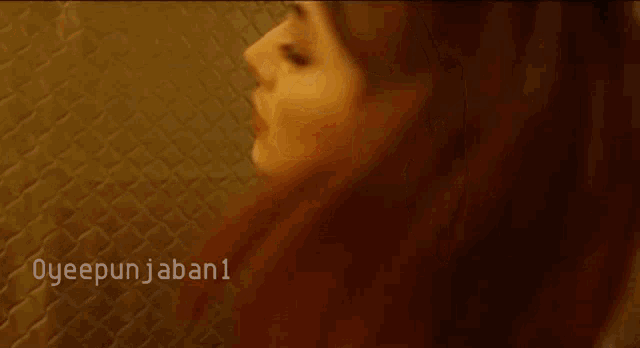 a close up of a woman 's face with the words oyeepunjaban1 below her