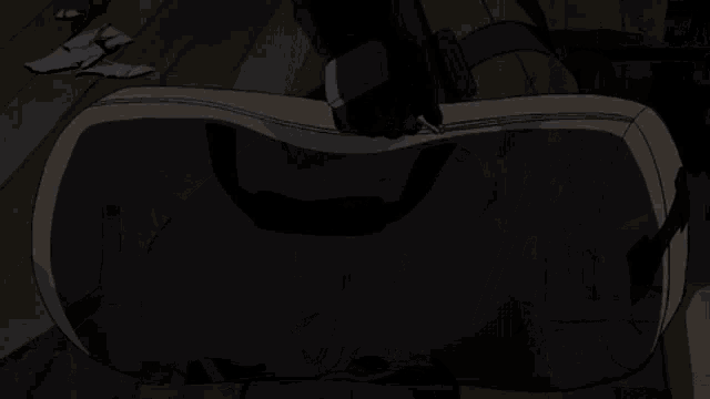 a person is sitting on a chair in the dark .