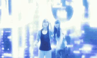 two women are dancing in front of a sign that says ' first ' on it