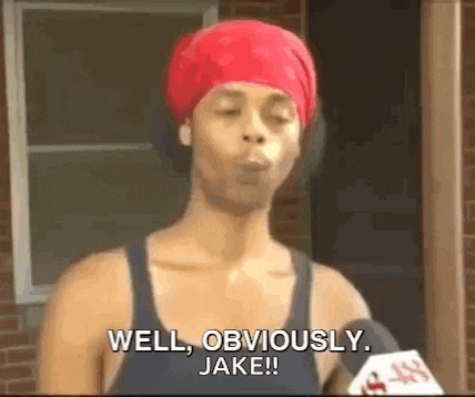 a woman wearing a red bandana is talking into a microphone and saying `` well obviously , jake ! ''
