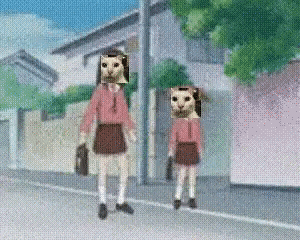 two girls with cat faces on their heads are walking down a street