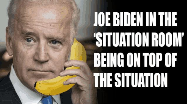 a picture of joe biden holding a banana in his mouth