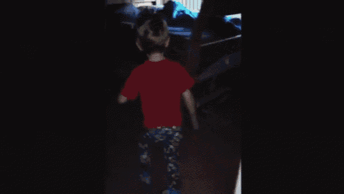 a young boy wearing a red shirt that says we laugh