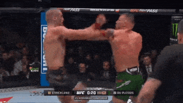 two men are fighting in a boxing ring and the ufc fight pass logo is visible