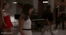 a cheerleader wearing a wmhs uniform is screaming in a classroom