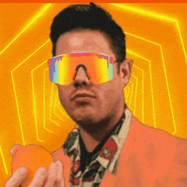 a man wearing pittsburgh sunglasses holds an orange