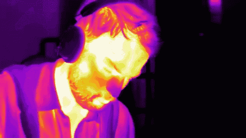 a purple and yellow image of a man with headphones on his head