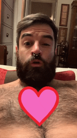 a man with a beard and a nose ring has a pink heart in front of his chest