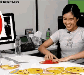 a woman wearing a shirt that says you can do it is sitting at a desk